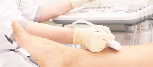 Ultrasound being carried out on patient's leg