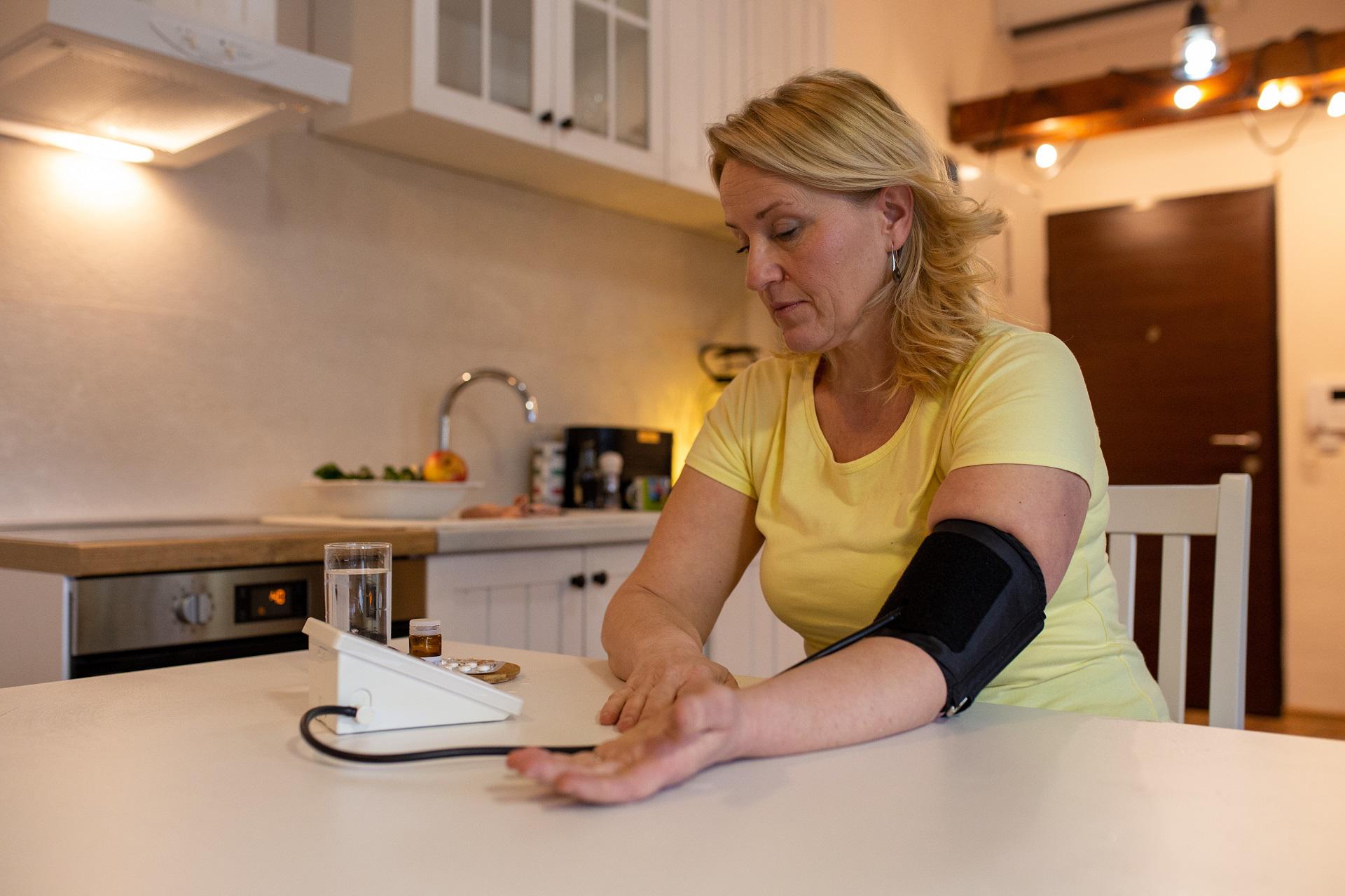 Woman measuring her blood pressure