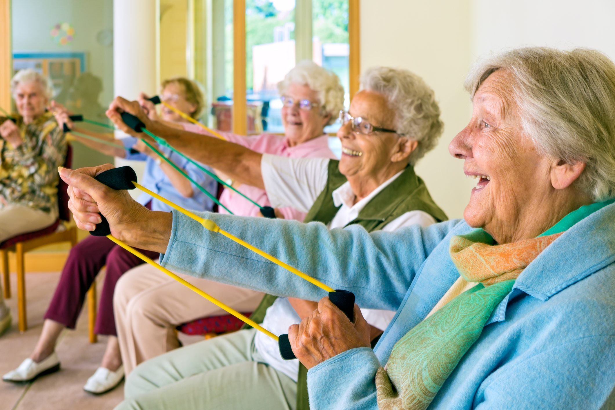 Elderly women doing resistance exercise to counteract sarcopenia