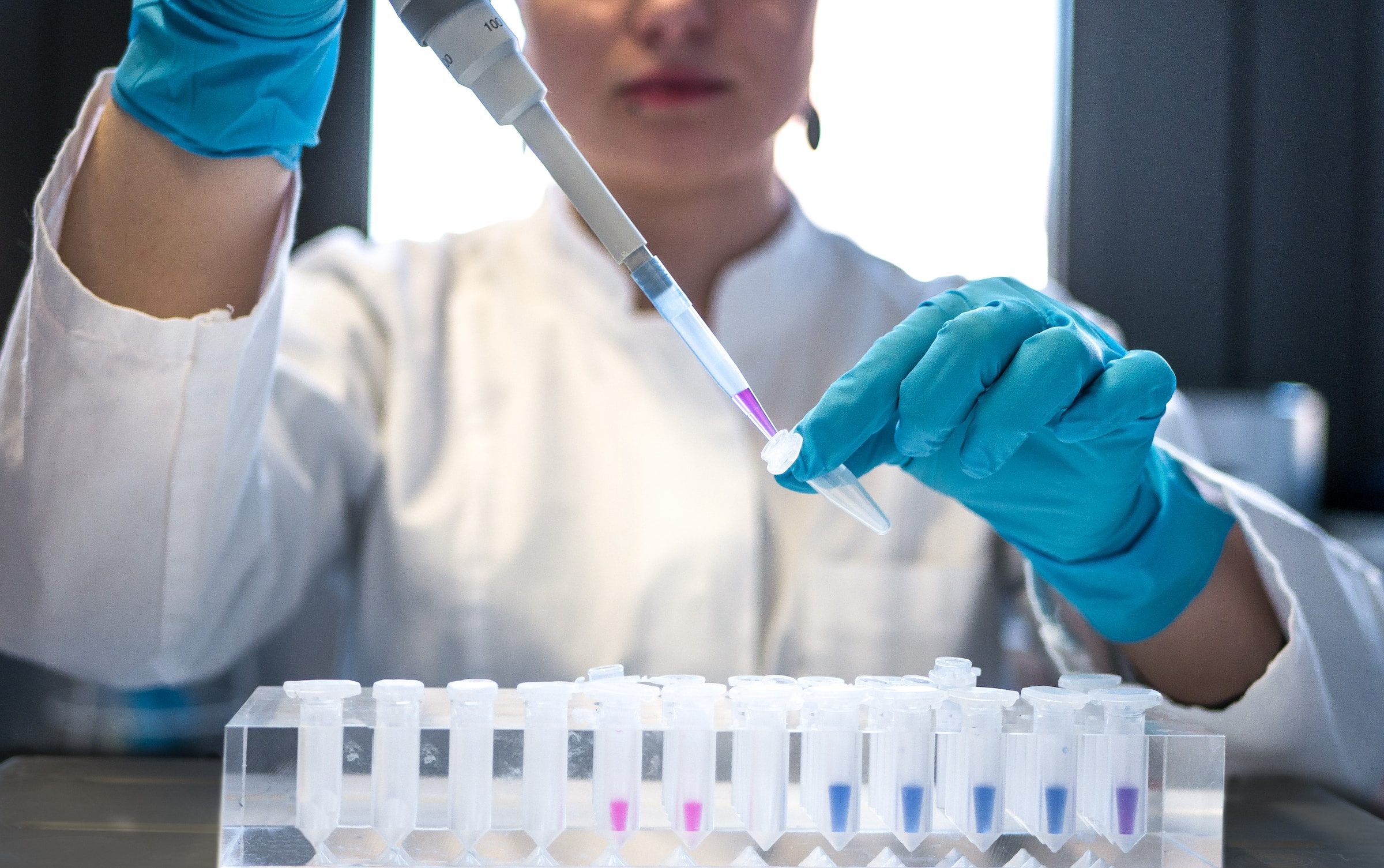 Researcher using pipette in a laboratory