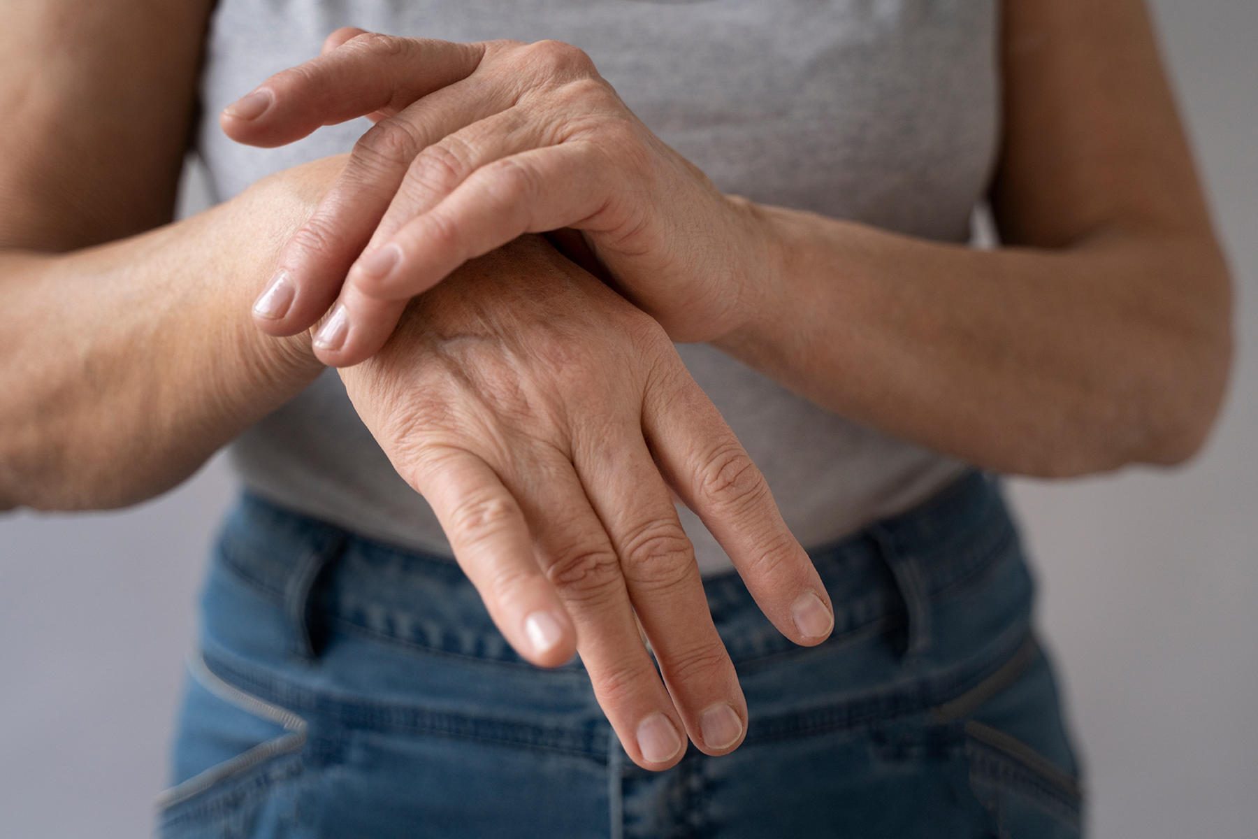 Middle aged woman holding her painful hand