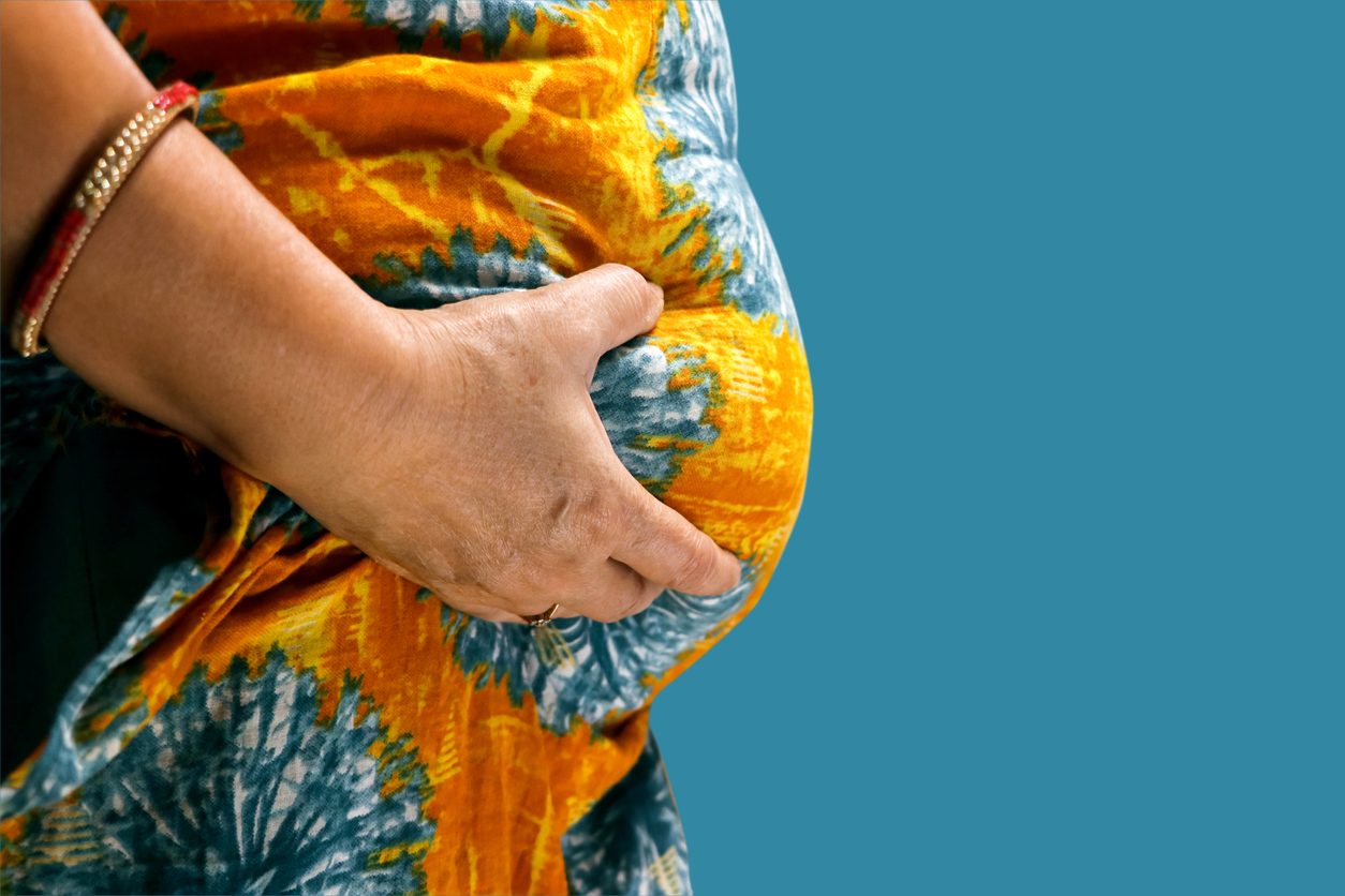 Woman pinching her abdomen