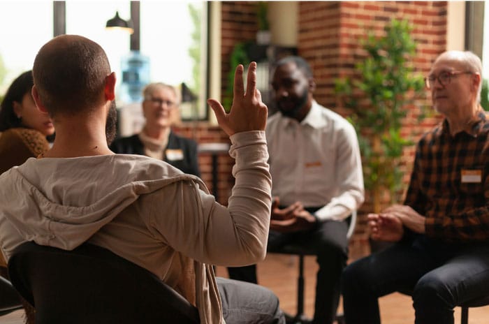 Group of people sitting down in conversation