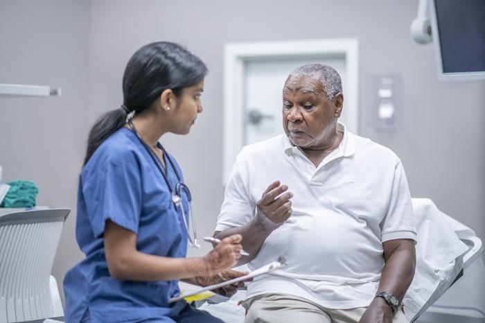 Medic talking to patient in clinical room