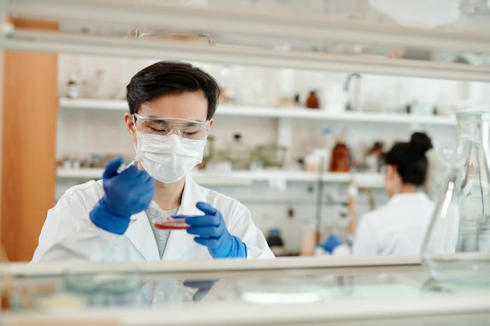 Researcher in laboratory using pipette