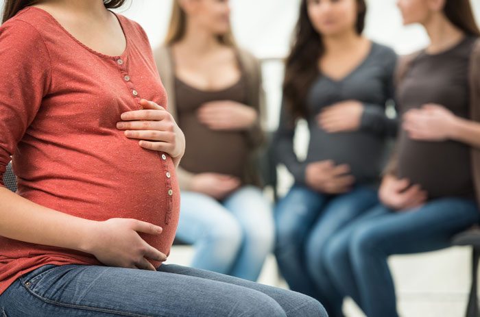 Pregnant women sitting in group discussion