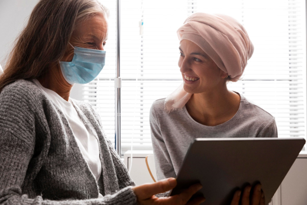 Patient wearing face mask and in discussion with another patient