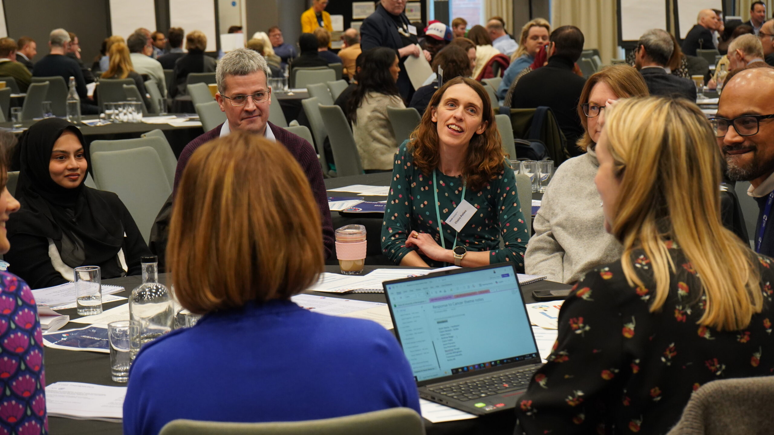 Table of attendees engaging in conversation