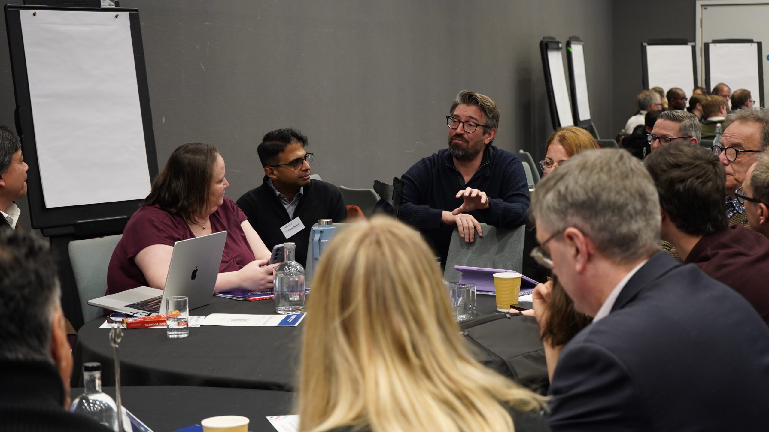 Table of attendees engaging in conversation