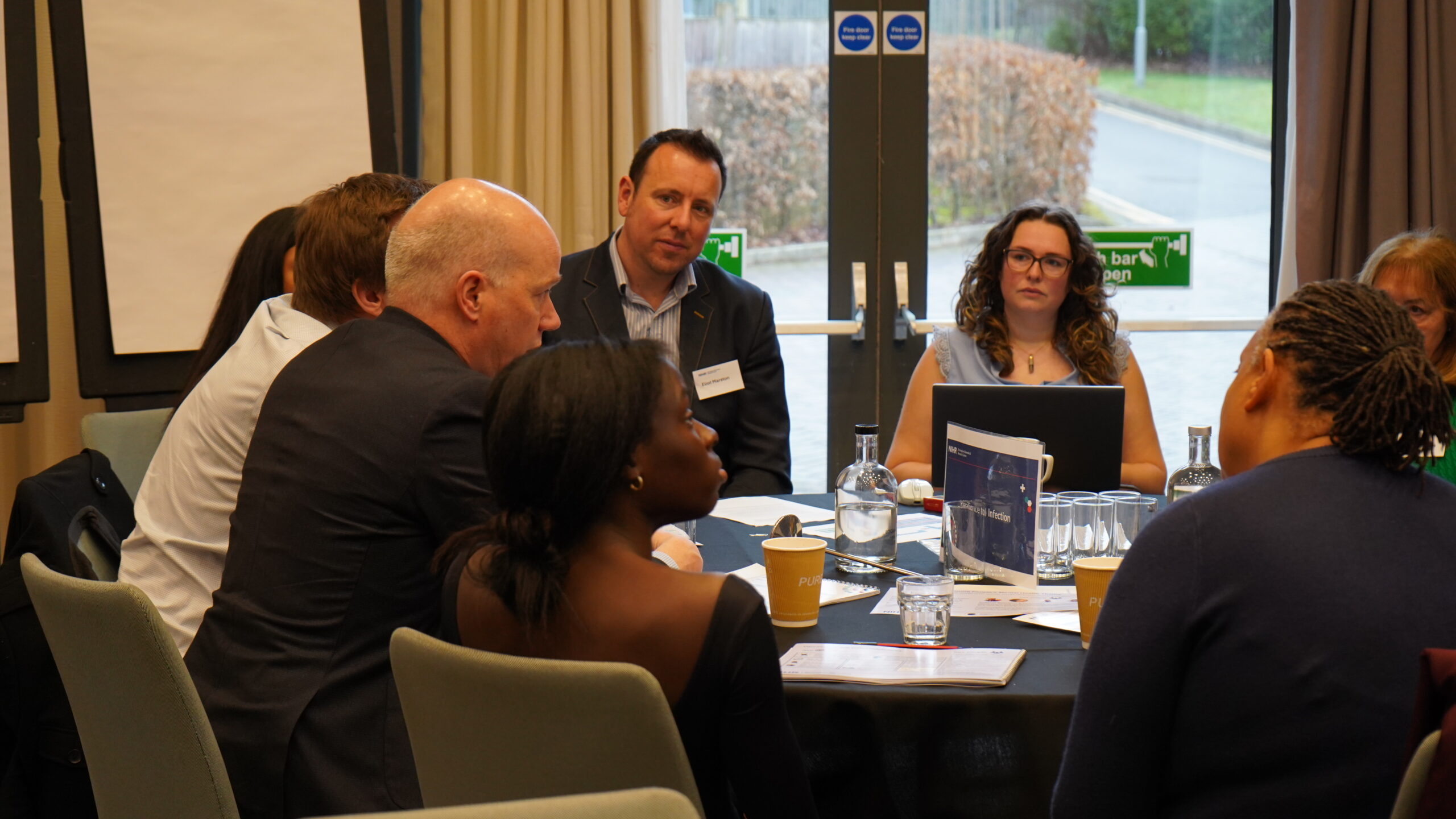 Table of attendees engaging in conversation
