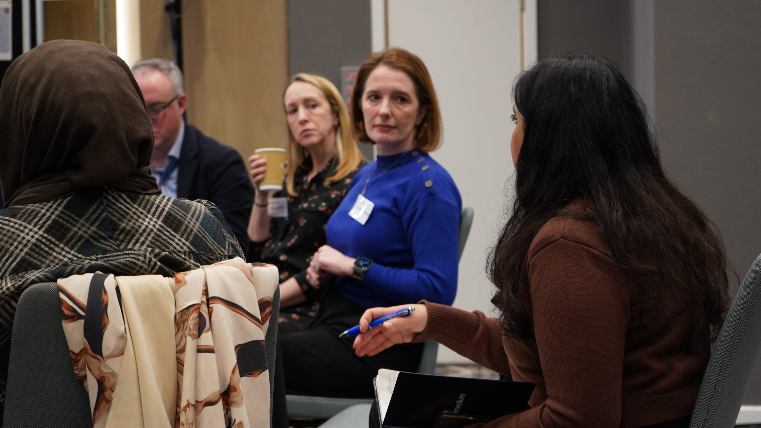 Table of attendees engaging in conversation