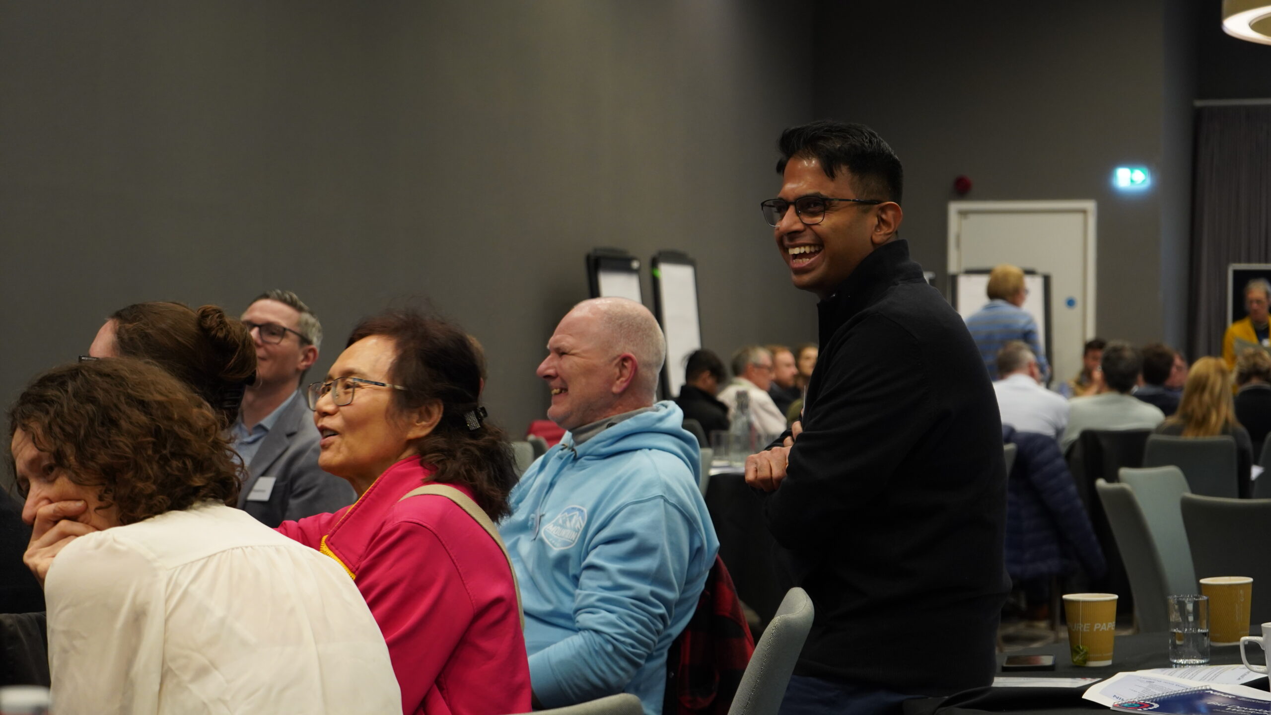Table of attendees engaging in conversation