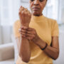 Woman at home with wrist pain