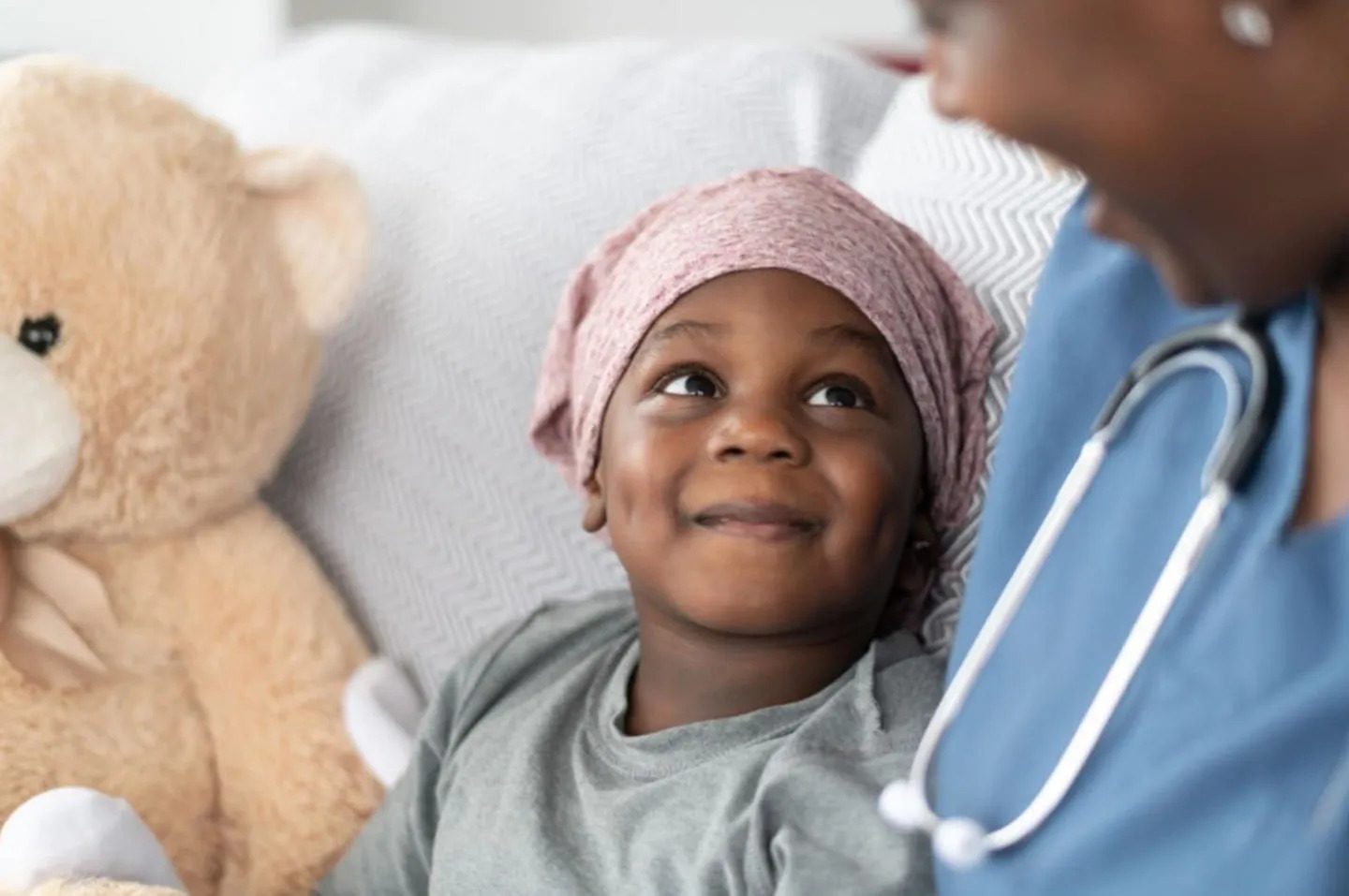 Child in a cancer ward with healthcare professional