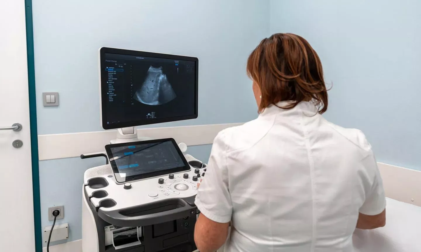 Healthcare professional looking at a liver ultrasound scan