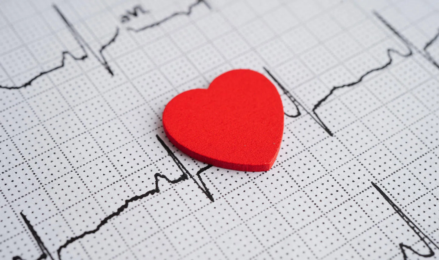 ECG results and red wooden heart on top