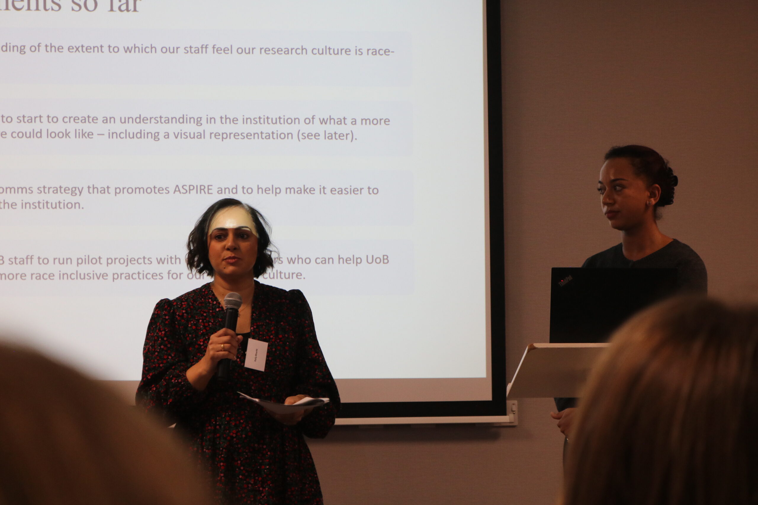 Kally Bhartti and Olivia Barfi presenting on stage