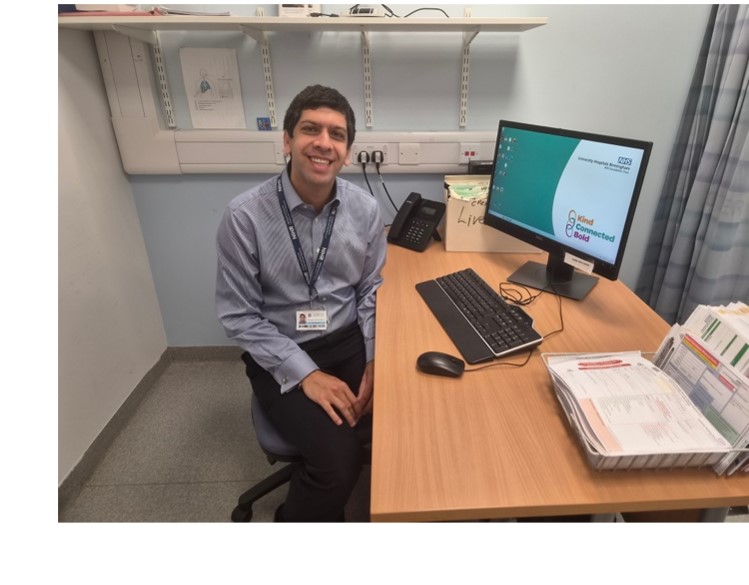 Dev sitting at his desk, where he looks after patients wtih HCC.
